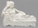 an image of a statue of a woman laying on a bed