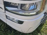 a close up of the front of a white truck