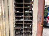 a rack of wooden planks on the side of a building