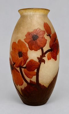 a vase with flowers painted on it sitting on a table