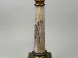 an image of a marble pedestal with a lamp on top