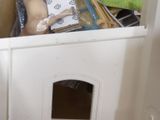 a doll house with a dog door in the corner of the room