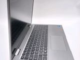 a silver laptop computer sitting on top of a white table