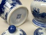 three blue and white vases sitting next to each other