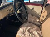 a car that is sitting in a parking lot with the door open