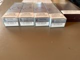 three boxes of creme cream sitting on a table next to a box of creme cream