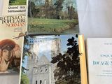 several books are sitting on a table with a white table cloth