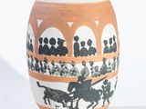 a vase with a picture of people riding horses on it