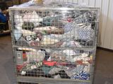 a cage filled with many pairs of shoes in a warehouse
