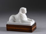 an image of a white statue of a monkey on a wooden base