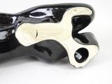a black and white sculpture of a hand holding a wrench