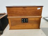 a small wooden box with a metal latch on it