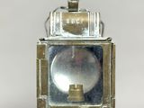 a small metal lantern with a light inside of it