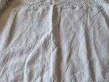 a white shirt that is laying on top of a bed