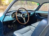 a dashboard and steering wheel of a classic car