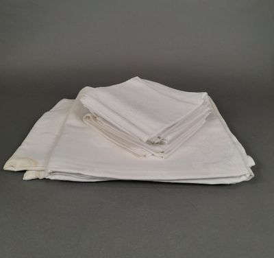 a stack of four folded white napkins on top of each other