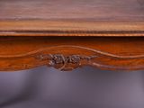 a close up of a wooden table with a leather top
