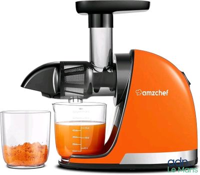un presse-agrumes avec un verre de jus d'orange à côté