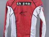 a close up of a red and white jacket hanging on a hanger