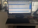 a desk with a computer monitor and a keyboard on it