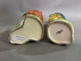 pair of colorful ceramic vases on white surface with white background