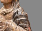 a statue of a woman holding a flower in her hands