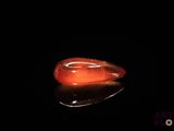 an image of a red stone on a black surface