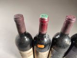 four bottles of wine are lined up in a row