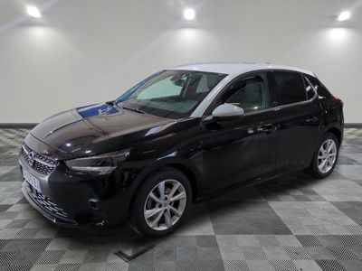 the black and white car is parked on a checkered floor