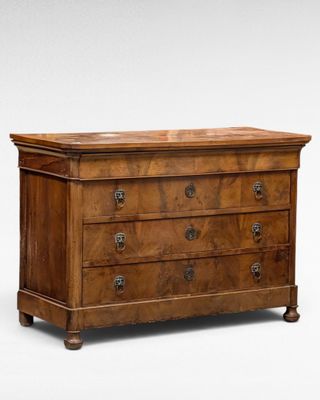 an antique chest of drawers with a wooden top