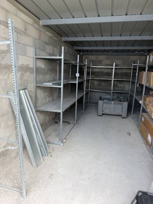 a room with shelves and boxes of items in it