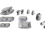 several pieces of blue and white porcelain are arranged on a white surface