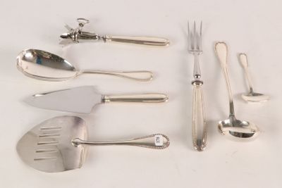 a lot of silverware on a white table