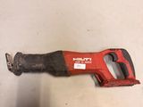 a close up of a red and black hand saw on a table