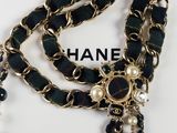 a close up of a chanel necklace with pearls on it