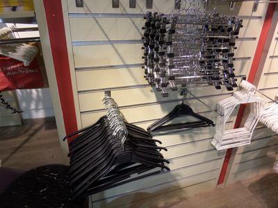 many hangers on the wall of a clothing store