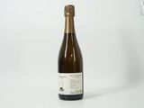 the bottle of wine is sitting on a white surface