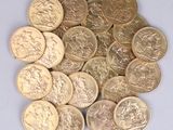 a pile of gold coins sitting on a white surface