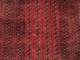a red and black rug with a square design on it