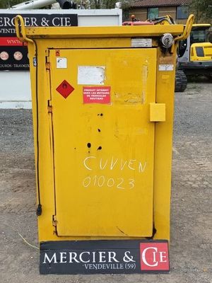 a yellow box with a sign on it in front of a building