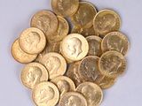 a pile of gold coins on a white surface