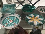 a glass display case with a lot of colorful dishes on it