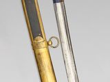 an image of a gold and silver sword with a black handle