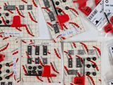 a lot of red and black legos on a white table