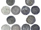 several silver coins are arranged in a circle on a white surface