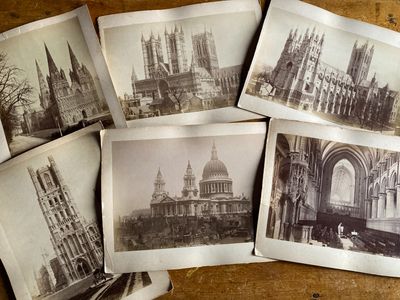 several old black and white photos of cathedrals and buildings on a table