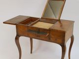 a small wooden table with a mirror on top of it