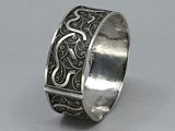 a close up of a silver ring on a gray surface