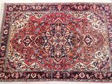 a close up of an oriental rug on a white surface