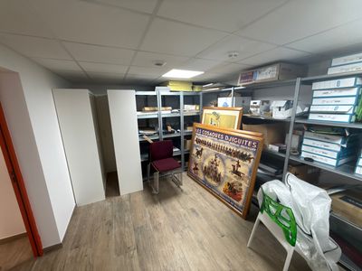an image of a room with a lot of shelves and a chair